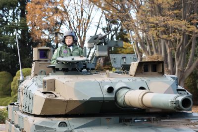 Japanese Prime Minister Fumio Kishida takes a ride in a tank during his visit to the Ground Self-Defense Force's Asaka base, Tokyo, Japan, 27 November 2021 (Photo: Reuters/Kyodo).