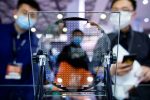 Visitors look at a display of a semiconductor device at Semicon China, a trade fair for semiconductor technology, in Shanghai, China on 17 March 2021 (Photo: Reuters/Aly Song).