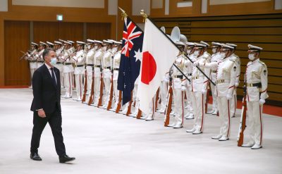 Australian Deputy Prime Minister and Minister of Defence Richard Marles receives a salute from a guard of honour in Tokyo on 14 June 2022 (The Yomiuri Shimbun via Reuters).