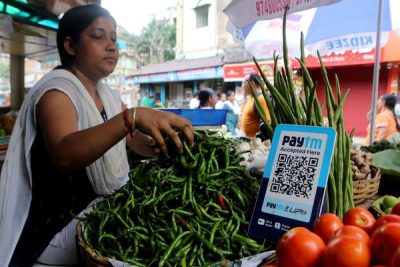 A vegetable vendor waits for customers displaying a barcode for Paytm, India's mobile-based digital payment platform, Kolkata, India, July 4, 2023 (Photo: Reuters/Debajyoti Chakraborty).